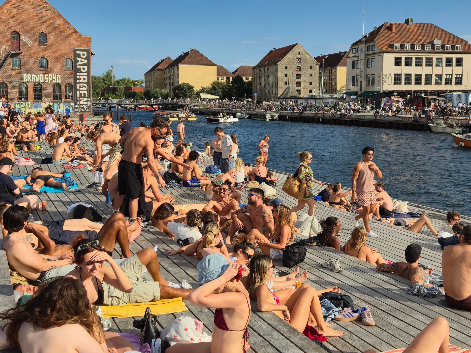 The packed Papirøen sun deck on the Copenhagen harbour on a hot July day