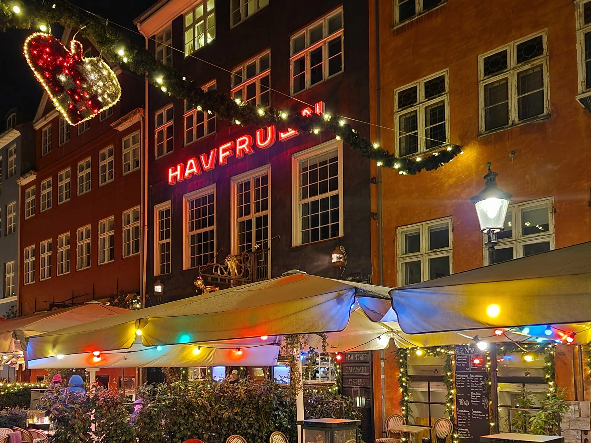 Nyhavn's restaurants lit up with Christmas hearts and garlands in December