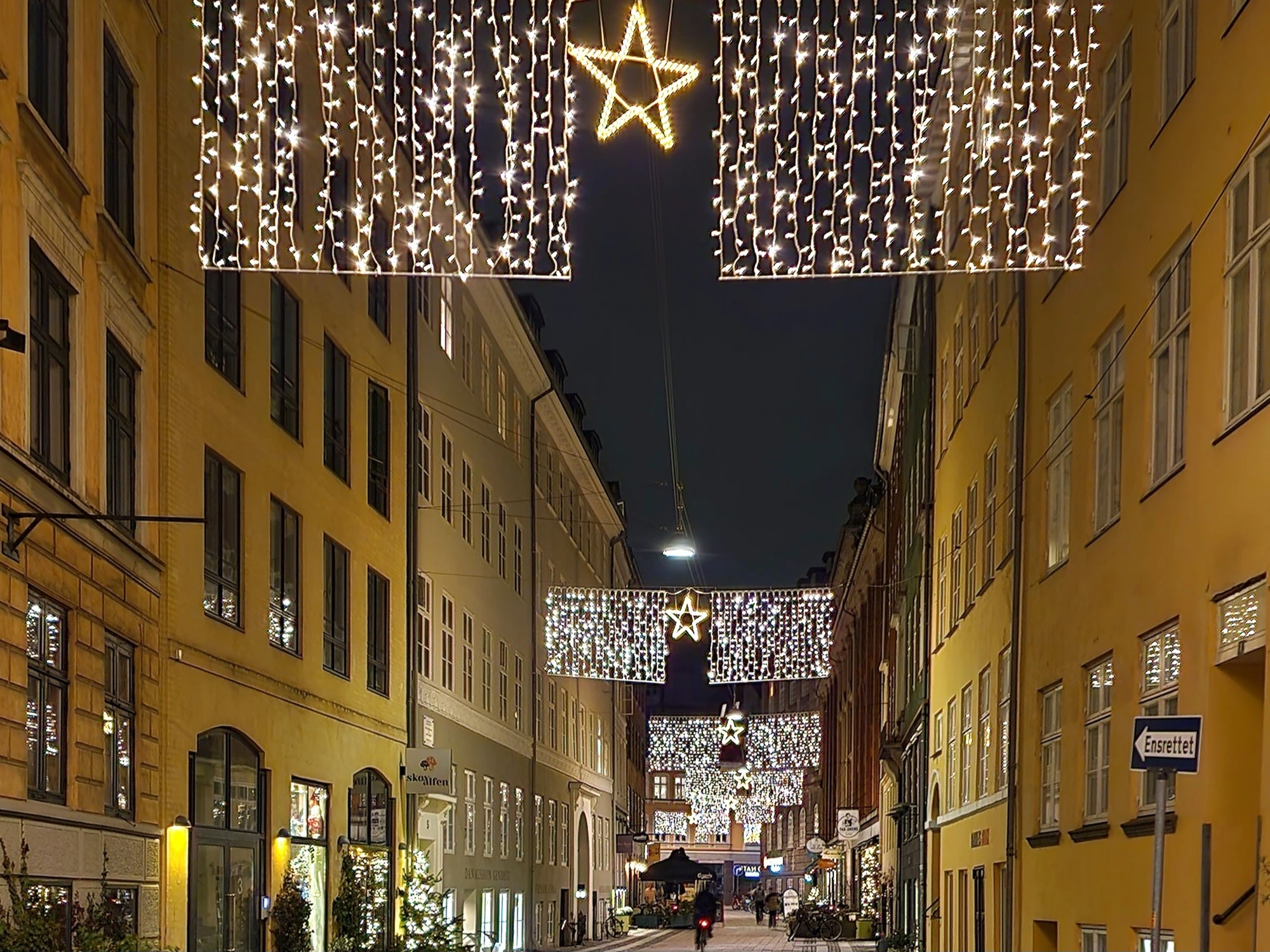 Star-shaped Christmas lights strung across a Copenhagen side street