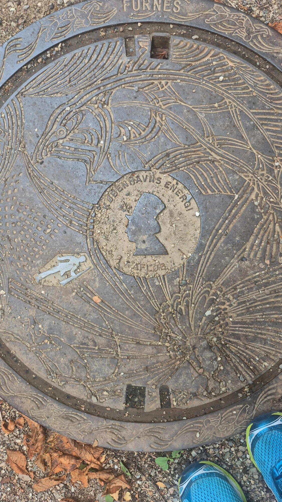 Cast-iron manhole cover with H.C. Andersen's profile silhouette