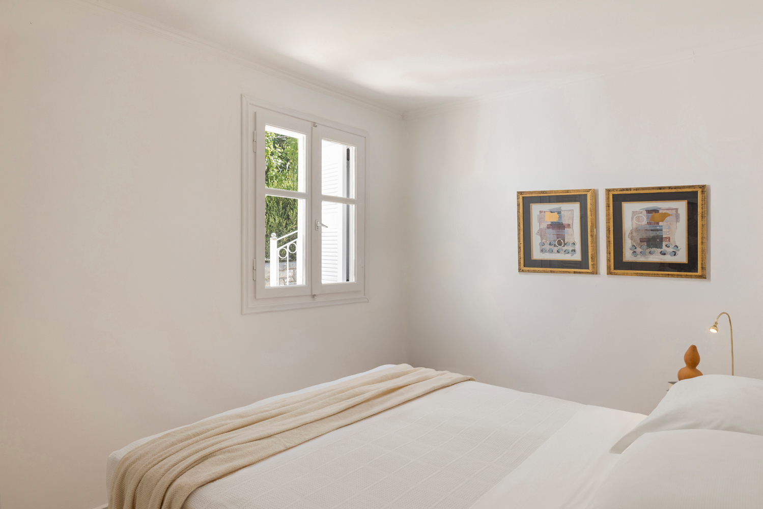 Primary bedroom with garden view through the window