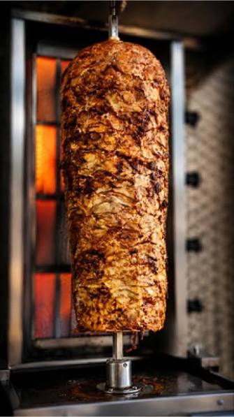 Hyderabadi shawarma rotisserie slowly roasting over the grill