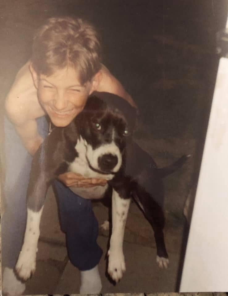 Teen Greg holding a dog