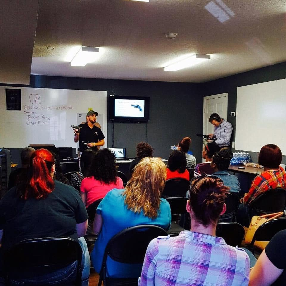 Greg teaching a classroom with Jesse Fox — Women's Protection Services